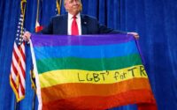 Republican presidential nominee Donald Trump holds up a rainbow flag with "LGBT's for TRUMP" written on it at a campaign rally in Greeley, Colorado, U.S. October 30, 2016. - Reuters