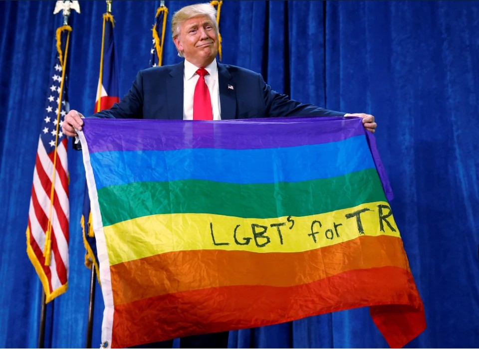 Republican presidential nominee Donald Trump holds up a rainbow flag with "LGBT's for TRUMP" written on it at a campaign rally in Greeley, Colorado, U.S. October 30, 2016. - Reuters